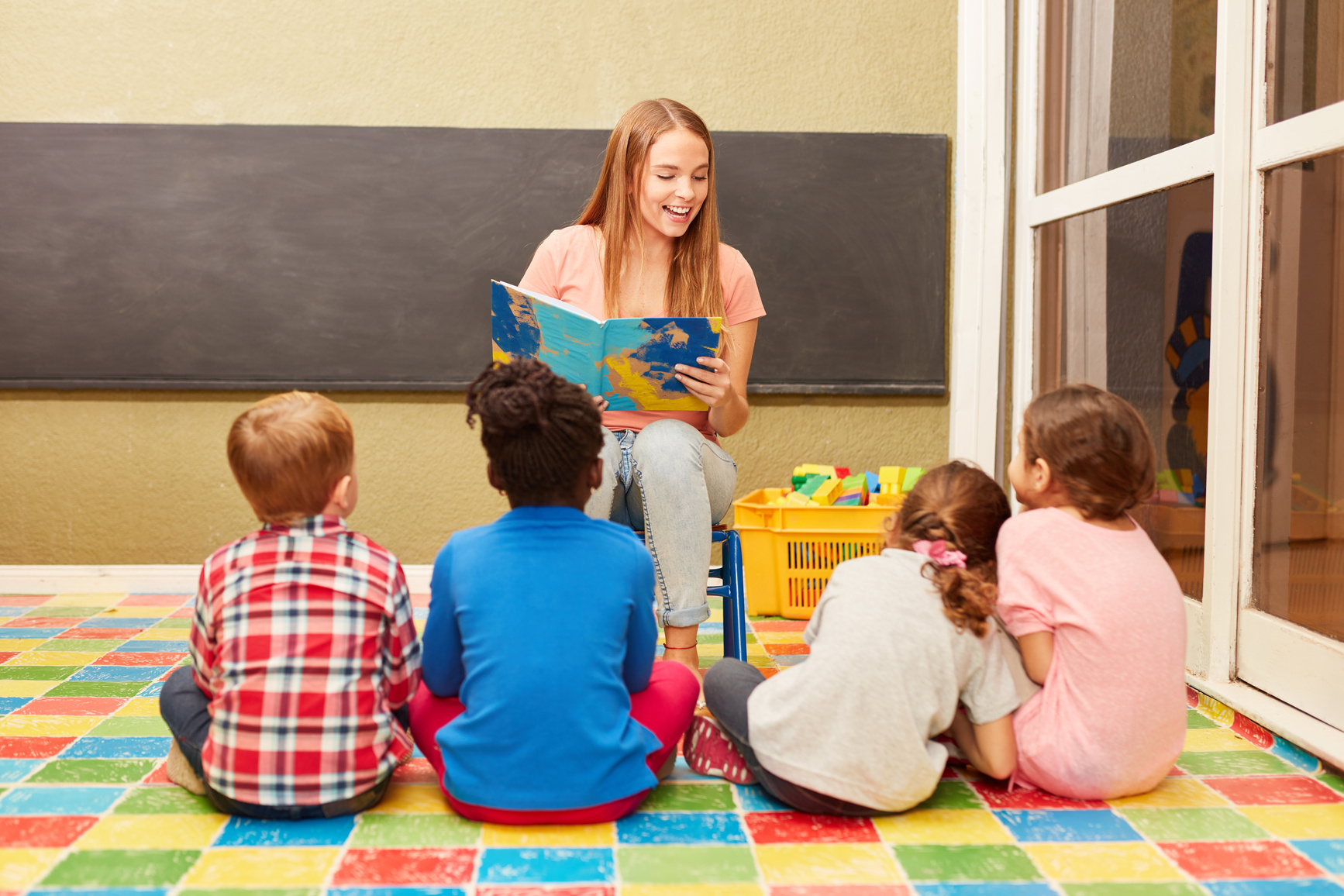 Teacher Reading a Book to Preschool Children